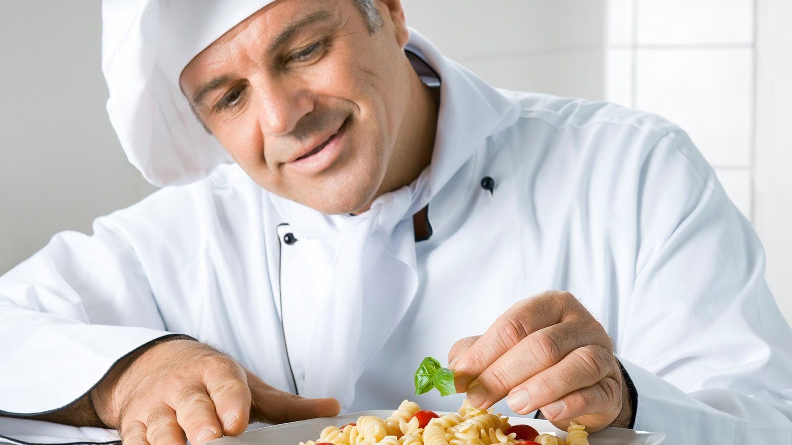 Personal chef plating a fresh dish on-site for WSG Services